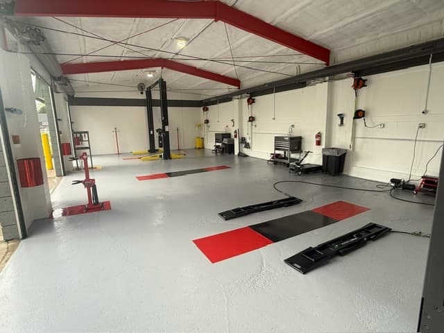 Coopers DIY Garage interior with multiple bay setups and red accent flooring