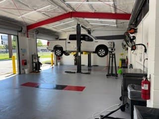 A customer's vehicle on a lift at Coopers DIY Garage